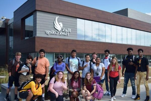 students pose in front of the Building 1 addition